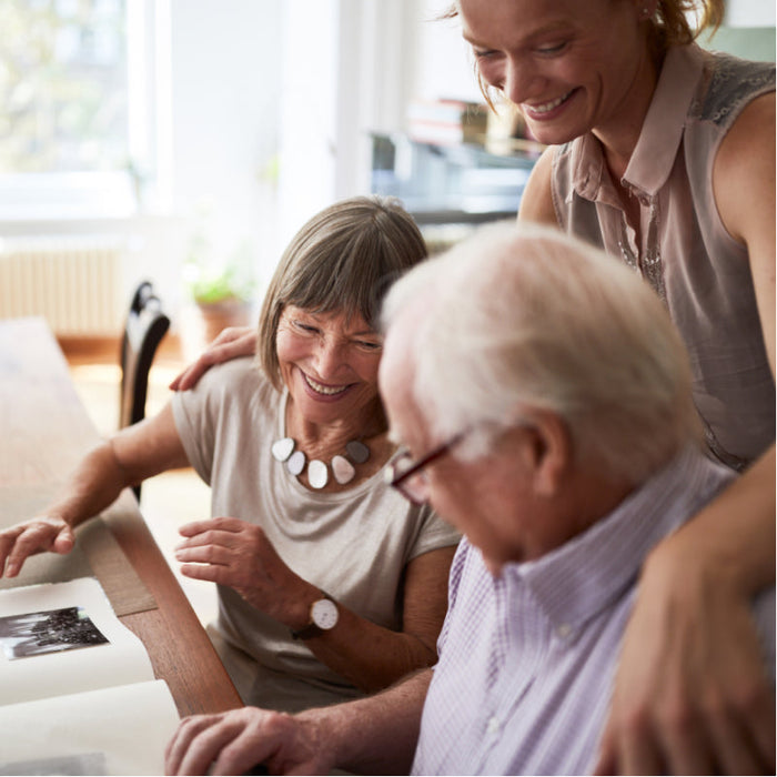 Family around a table talking about MoliCare Products